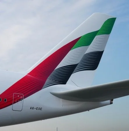 Close-up of an airplane tail with the Italian flag colors: green, white, and red.