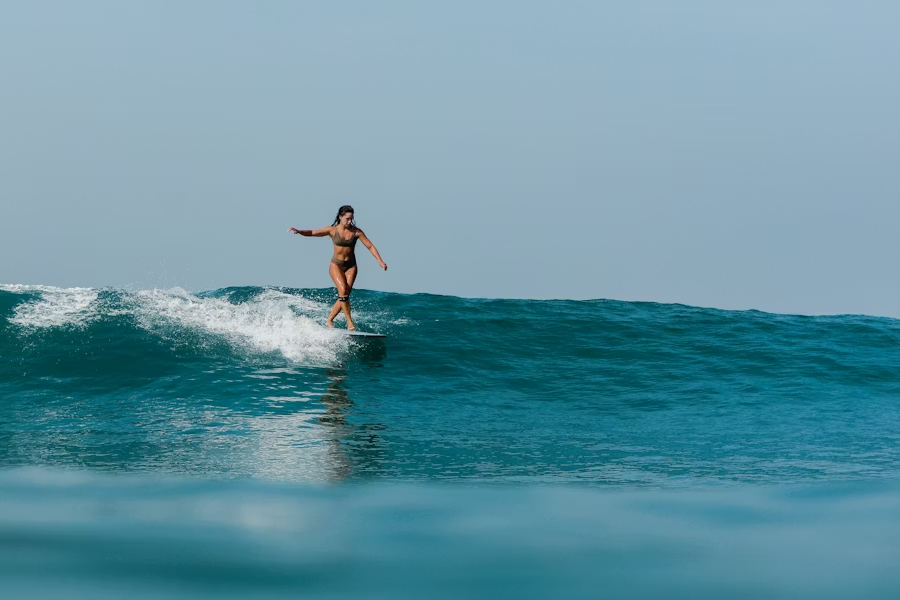 A woman surfing on the ocean waves.