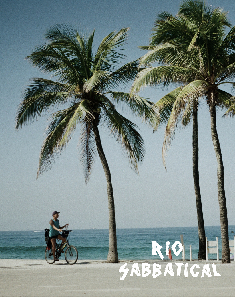 A woman with a bicycle on a sandy beach with palm trees and the ocean in the background, under a clear blue sky, with 'Rio Sabbatical' written in white text at the bottom right. Rio Sabbatical program by Hyperlocal World of Travel.