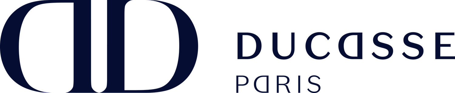 Ducasse Paris logo in navy blue with a stylized 'D' inside an oval.