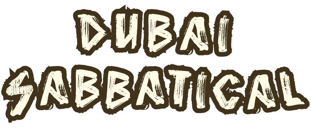 Text reading "Dubai SABBATICAL" in a stylized, graffiti-like font on a black background.